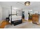 Elegant bedroom featuring a four-poster bed and access to closet space at 1051 Independence St, Lakewood, CO 80215