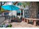 Inviting patio with an umbrella, stone flooring, and a charming stone bench beside the home's entrance at 1051 Independence St, Lakewood, CO 80215