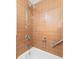 Clean bathroom features a combination shower-tub and bronze tiled wall at 800 Washington St # 302, Denver, CO 80203