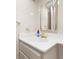Clean bathroom featuring a white countertop, a golden-framed mirror, and classic tiled walls and fixtures at 800 Washington St # 302, Denver, CO 80203