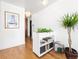 Bright hallway area with hardwood floors, a plant stand, and unique decor at 800 Washington St # 302, Denver, CO 80203