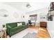 Comfortable home office with a green sofa, modern desk setup, and hardwood floors with natural light at 800 Washington St # 302, Denver, CO 80203