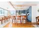 Bright kitchen featuring blue cabinets, wood countertops, a chandelier, and seating at the kitchen island at 800 Washington St # 302, Denver, CO 80203