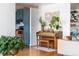 Cozy living room with a piano, plants, and hardwood floors, offering a bright and inviting space at 800 Washington St # 302, Denver, CO 80203