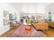 Spacious living room with a large patterned rug, a leather couch, and bright natural light at 800 Washington St # 302, Denver, CO 80203