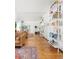 Bright living area with hardwood floors, a comfortable leather couch, and shelving units at 800 Washington St # 302, Denver, CO 80203