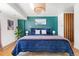 Stylish bedroom featuring a large bed with blue bedding, green accent wall, and contemporary decor with a cozy feel at 800 Washington St # 302, Denver, CO 80203