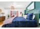 Beautiful bedroom with a bed, colorful bedding, wooden floors and accents of natural light with a cozy feel at 800 Washington St # 302, Denver, CO 80203