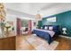 Bright and well-decorated bedroom with large windows, a comfortable bed, and hardwood floors with cozy style at 800 Washington St # 302, Denver, CO 80203