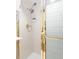 Modern shower with a sleek design, featuring a multi-setting showerhead and frosted glass door with gold trim at 800 Washington St # 302, Denver, CO 80203