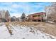 A spacious backyard featuring a large lawn, storage shed, and wood deck at 1520 Phillips Dr, Northglenn, CO 80233