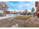 Large backyard featuring a spacious lawn, storage shed, and small bench at 1520 Phillips Dr, Northglenn, CO 80233