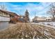 Spacious backyard featuring a large lawn, detached shed, and a wooden porch at 1520 Phillips Dr, Northglenn, CO 80233