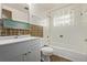 Bathroom features a white vanity with sink, a toilet, and a shower-tub combination at 1520 Phillips Dr, Northglenn, CO 80233