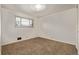 Cozy bedroom with neutral carpet and walls, and a window providing natural light at 1520 Phillips Dr, Northglenn, CO 80233