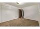 Spacious bedroom featuring neutral carpet, white walls, and a closet at 1520 Phillips Dr, Northglenn, CO 80233