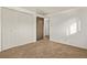 Bedroom featuring neutral carpet, white walls, a closet, and an open door at 1520 Phillips Dr, Northglenn, CO 80233