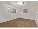 Sunlit bedroom with neutral carpet, white walls, and dual windows for natural light at 1520 Phillips Dr, Northglenn, CO 80233