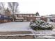 Attractive two-story home with snow covered lawn and brick facade, showcasing a bay window and a attached single car garage at 1520 Phillips Dr, Northglenn, CO 80233