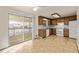 Functional kitchen with wooden cabinets, white appliances, and sliding glass doors to an outdoor deck at 1520 Phillips Dr, Northglenn, CO 80233