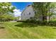 Spacious backyard with lush lawn, mature trees, and well-maintained landscaping enhances the property's curb appeal at 4797 Flower St, Wheat Ridge, CO 80033