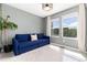 Bedroom with blue sofa bed, gray walls, carpet, and two windows at 4797 Flower St, Wheat Ridge, CO 80033