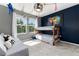Bedroom with bunk beds, gray sofa, and colorful wall art at 4797 Flower St, Wheat Ridge, CO 80033