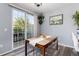 Charming dining area with a wooden table, clear chairs, and a sliding glass door at 4797 Flower St, Wheat Ridge, CO 80033