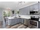 Modern kitchen with stainless steel appliances, white countertops, and gray cabinets at 4797 Flower St, Wheat Ridge, CO 80033
