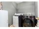 Laundry room including LG washer and dryer plus hot water heater and plenty of shelving for storage at 4797 Flower St, Wheat Ridge, CO 80033