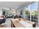 Open-concept living and dining area with wood floors and access to outdoor space at 4797 Flower St, Wheat Ridge, CO 80033