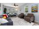 Bright living room with wood floors, ceiling fan, and an open, airy feel at 4797 Flower St, Wheat Ridge, CO 80033