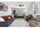 Spacious living room featuring modern decor, wood floors, and ample natural light at 4797 Flower St, Wheat Ridge, CO 80033