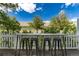 Enjoy outdoor dining with bar table and seating on the fenced patio, surrounded by lush greenery at 4797 Flower St, Wheat Ridge, CO 80033