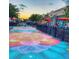 Vibrant street view with colorful sidewalk art and outdoor dining spaces at 4797 Flower St, Wheat Ridge, CO 80033