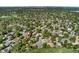 Expansive aerial view of a tree-lined neighborhood with the Denver skyline in the distance at 1713 S Holland St, Lakewood, CO 80232