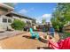 Enjoy this private backyard with a fire pit, play set, gravel, and patio area at 1713 S Holland St, Lakewood, CO 80232