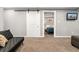 A finished basement featuring a sliding barn door and view into the bedroom at 1713 S Holland St, Lakewood, CO 80232
