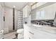 Beautiful bathroom with a walk-in shower, patterned tile accents and marble countertops at 1713 S Holland St, Lakewood, CO 80232