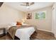 Bedroom features wood floors, natural light from the window, closet, and ceiling fan at 1713 S Holland St, Lakewood, CO 80232