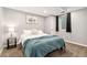 A finished basement bedroom featuring a queen bed, carpet floors, and a window at 1713 S Holland St, Lakewood, CO 80232