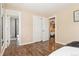 Inviting bedroom with wood floors, closet, and ensuite bathroom at 1713 S Holland St, Lakewood, CO 80232
