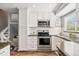 Beautiful kitchen featuring updated stainless steel appliances, granite counters, and ample storage space at 1713 S Holland St, Lakewood, CO 80232