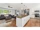 Bright kitchen with stainless steel appliances, granite countertops, and island flowing into the living room at 1713 S Holland St, Lakewood, CO 80232