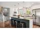 Bright, modern kitchen with a large island, stainless steel appliances, and white cabinetry at 1713 S Holland St, Lakewood, CO 80232