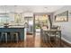 Kitchen and dining area featuring stainless steel appliances, island with seating, sliding glass doors to outside patio at 1713 S Holland St, Lakewood, CO 80232