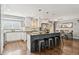 Open kitchen featuring granite countertops, stainless appliances, large island with bar seating and dining room access at 1713 S Holland St, Lakewood, CO 80232