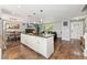 Spacious open floor plan with kitchen island, stainless appliances, granite countertops flowing to dining room and living room at 1713 S Holland St, Lakewood, CO 80232