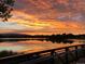 Stunning sunset over a tranquil lake, reflecting vibrant colors; very scenic at 1713 S Holland St, Lakewood, CO 80232