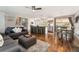 Open-concept living area with a kitchen island, living room seating, and a dining area at 1713 S Holland St, Lakewood, CO 80232